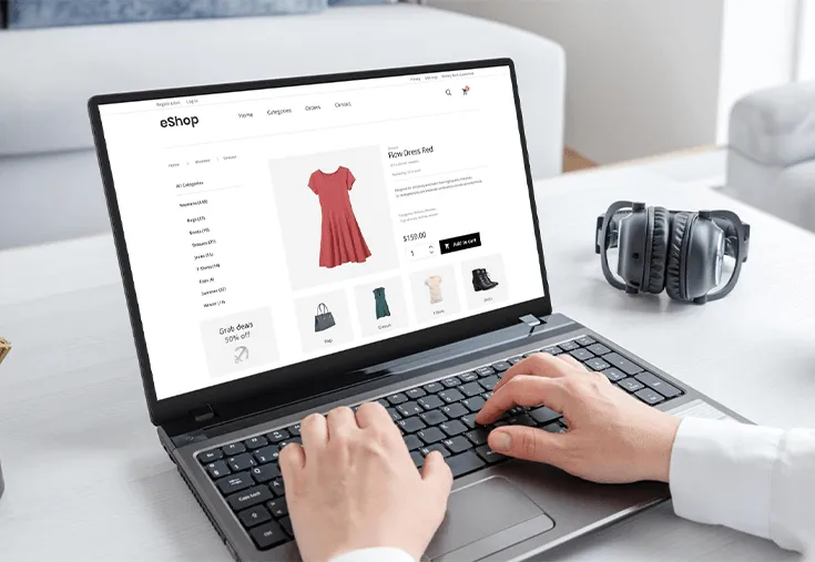Personne face à son pc occupée à consulter une boutique en ligne