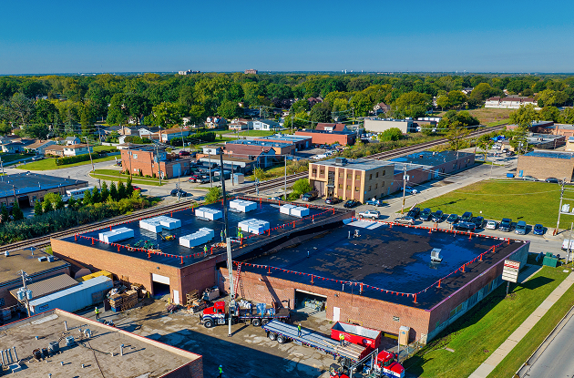 Commercial flat roof in Chicago with white TPO membrane on industrial building