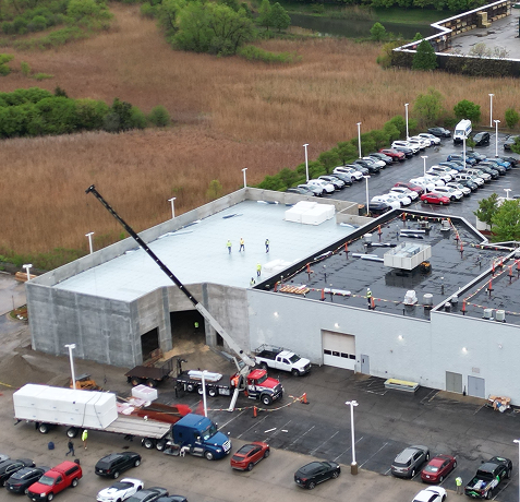 Flat roof maintenance and repair on commercial building fixing membrane damage