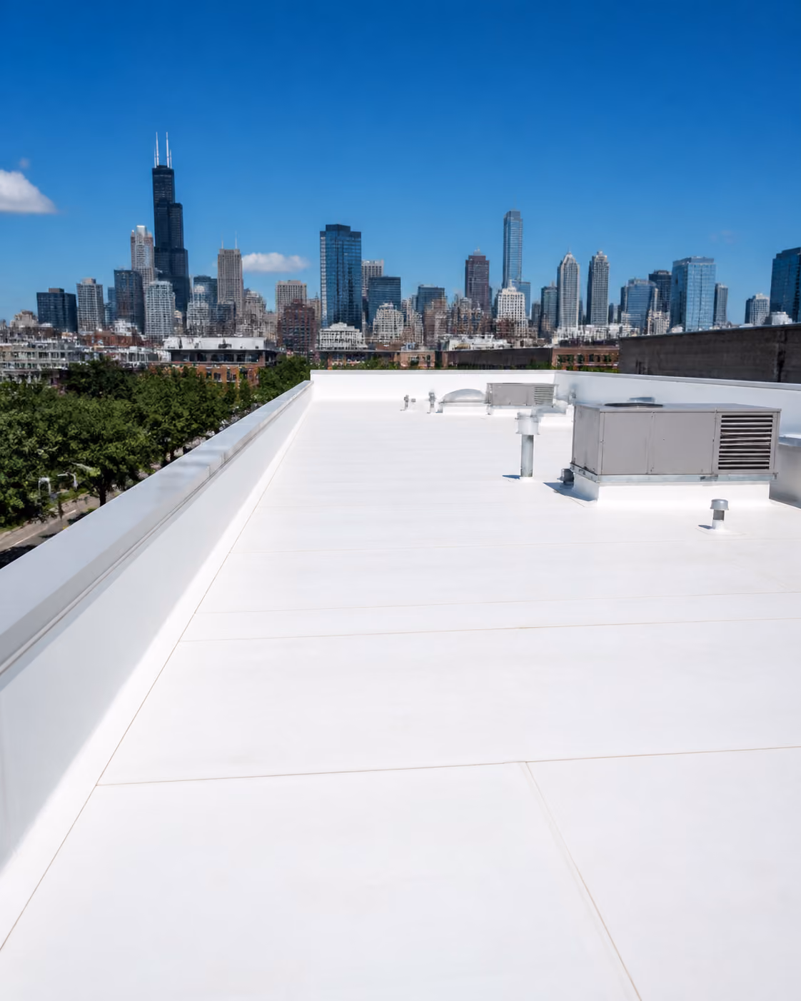 Reflective white TPO roof on a commercial building with the Chicago skyline