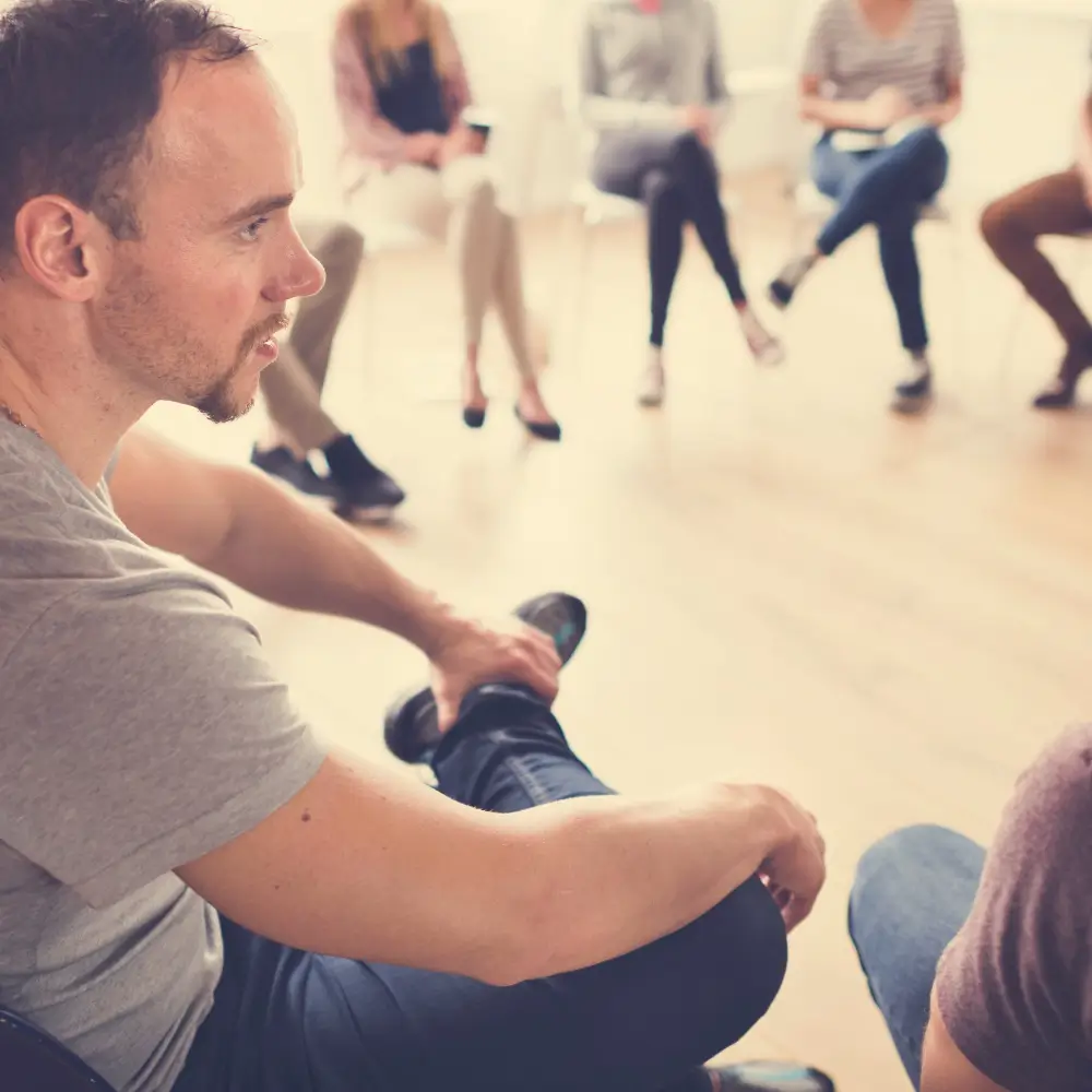 Individual participating in a group session with peer support