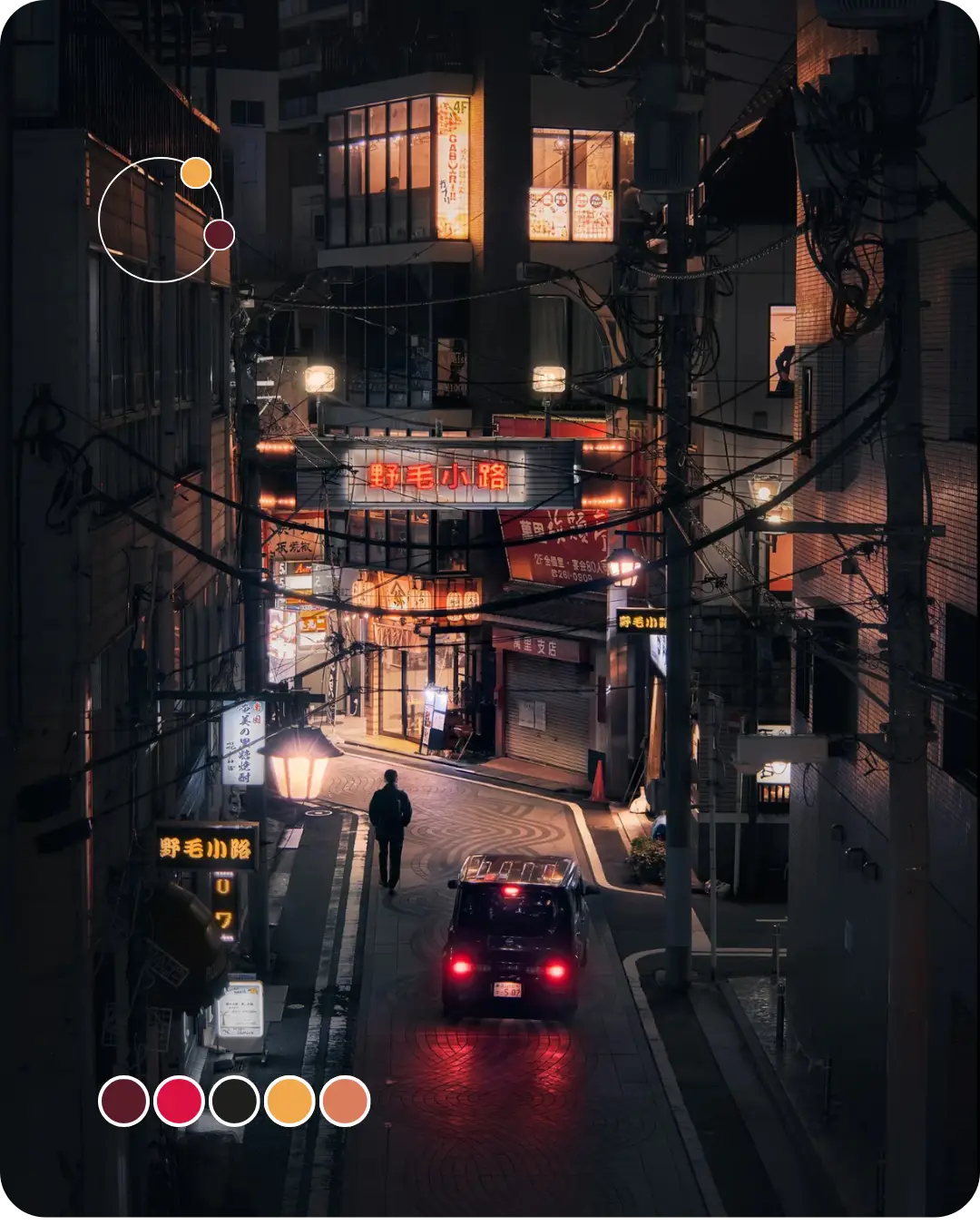 Callejón de Tokio de noche, con los carteles luminosos y los faros de un coche tiñendo la escena de naranjas y rojos