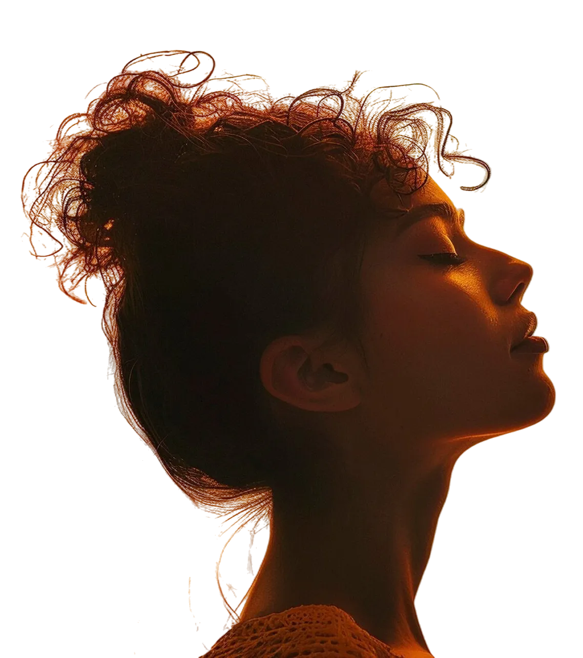 Side profile of a woman with curly hair in a bun, eyes closed, illuminated by warm orange light.