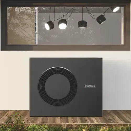 Schwarzes Buderus-Heizsystemgerät unter einem Fenster mit reflektierenden Deckenleuchten.