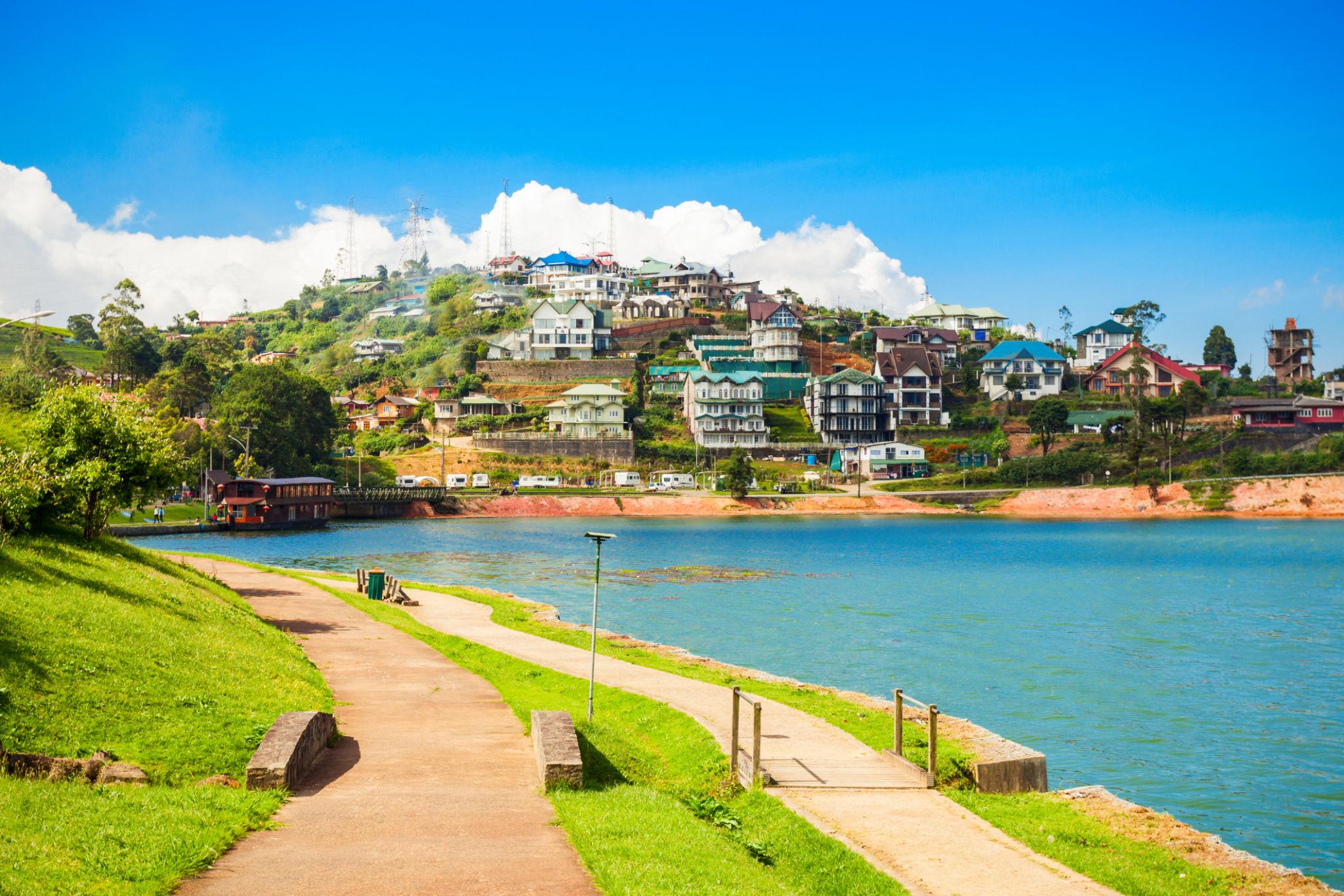 A stunning view of the lake Gregory and houses on the hill in Nuwara Eliya Sri Lanka
