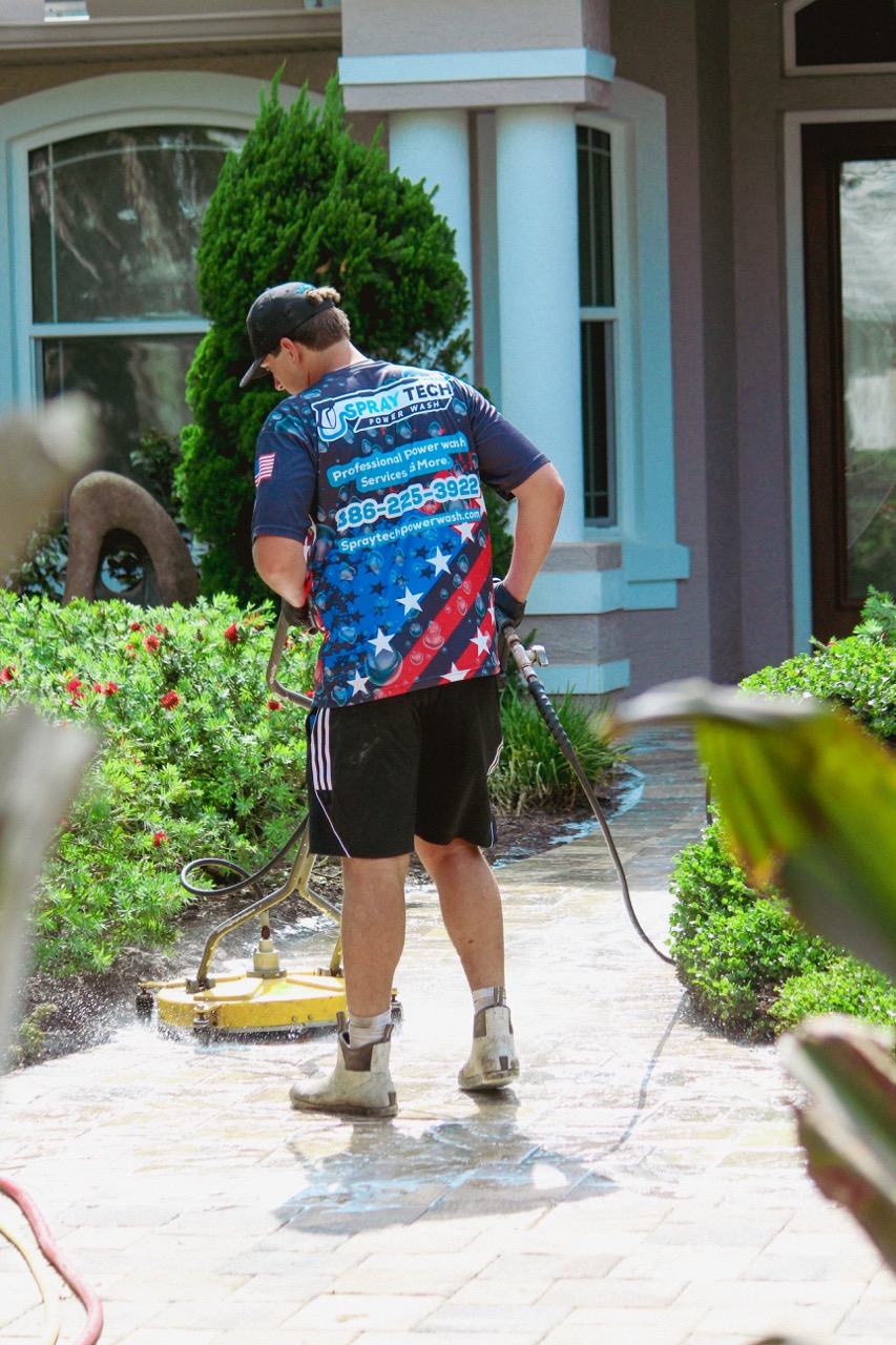 SprayTech soft washing a Florida home exterior