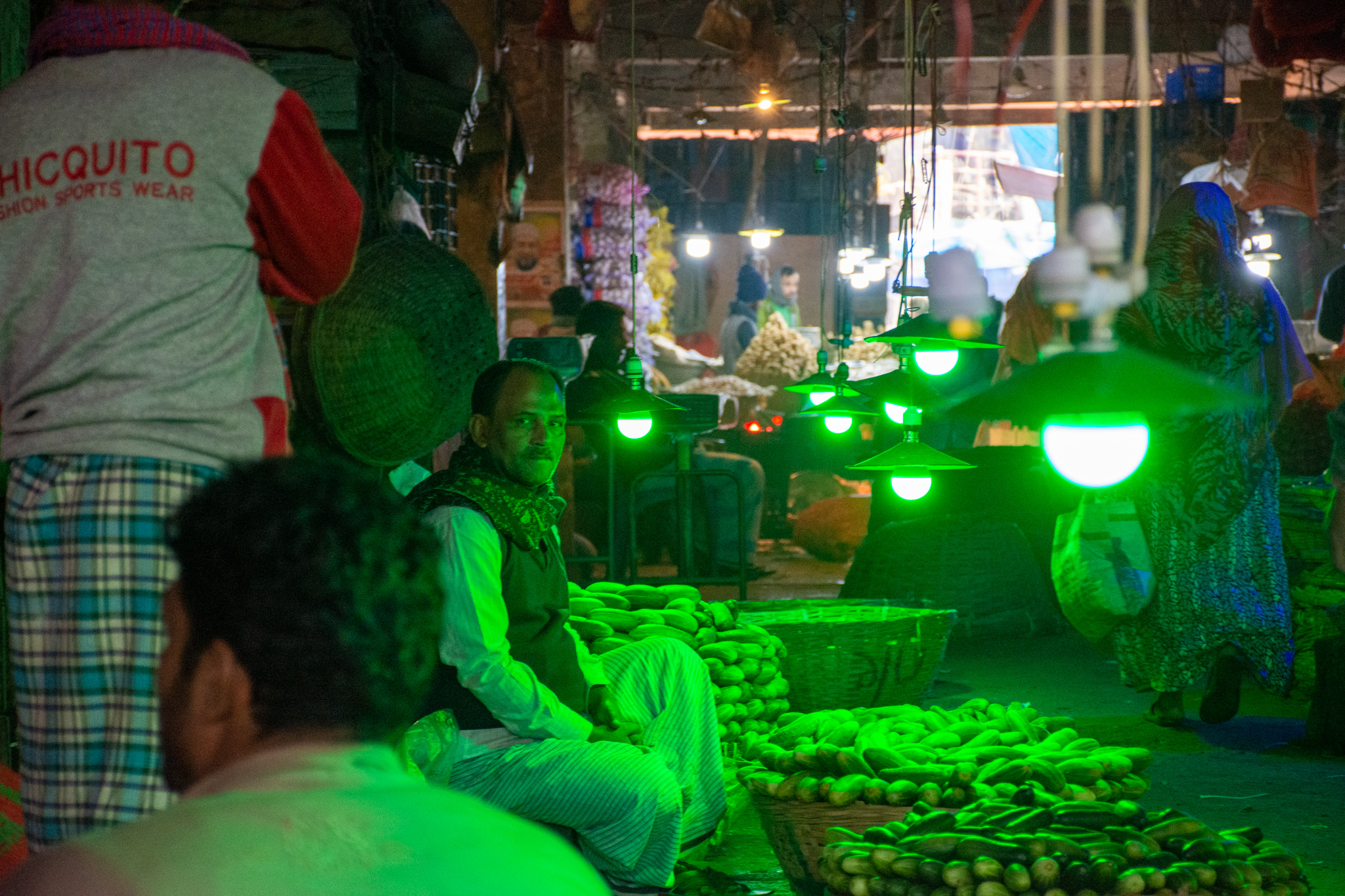 Man sitting on the floor at a market in dhaka Bangladesh.