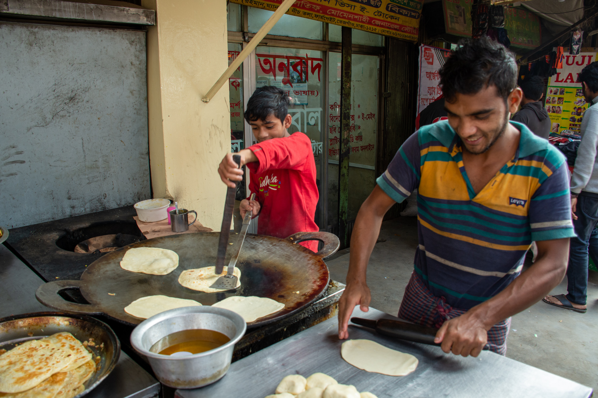 Children selling street food in Dhaka, Bangladesh.