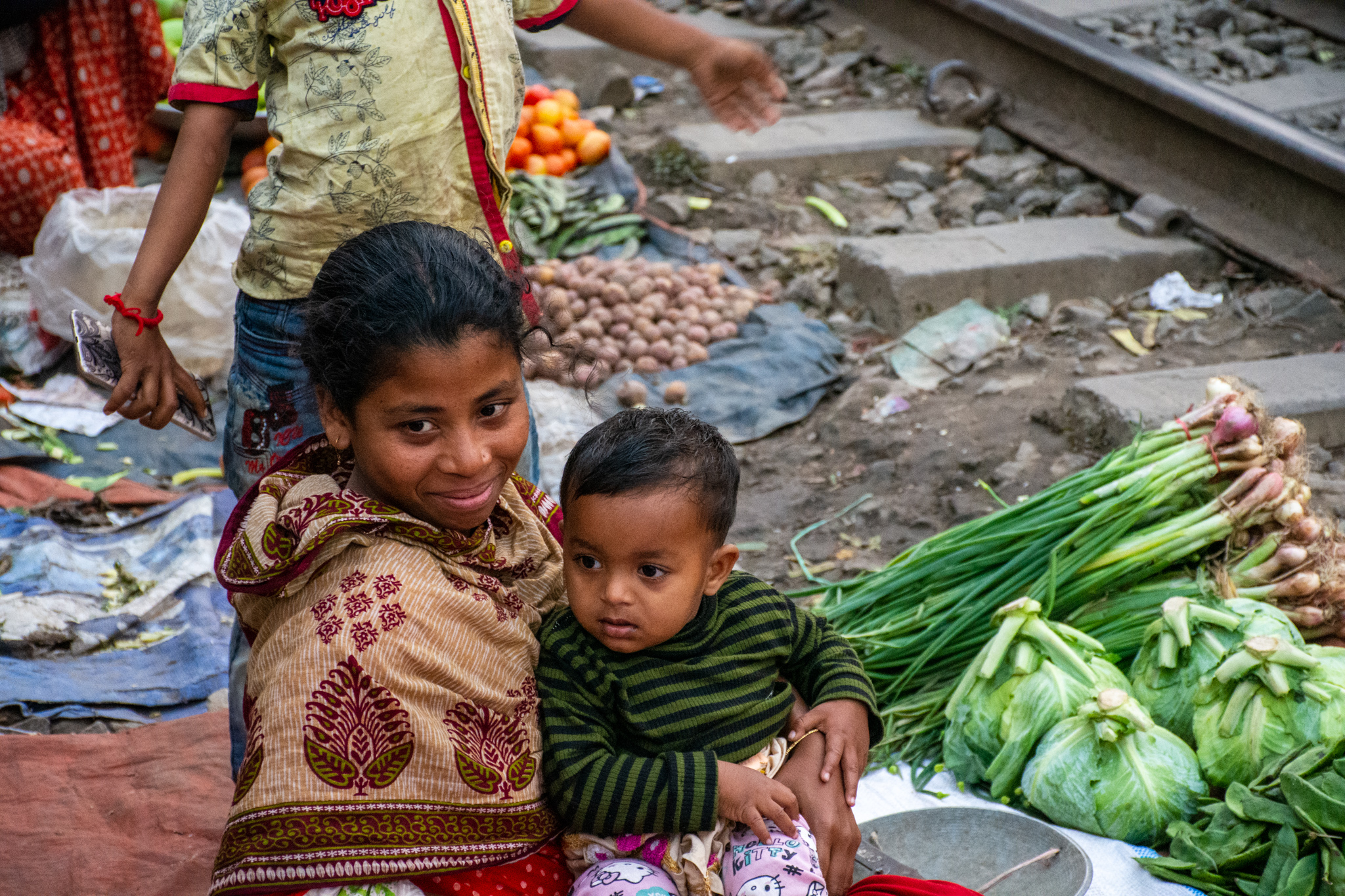 Woman and child in the slums at a rail way market.
