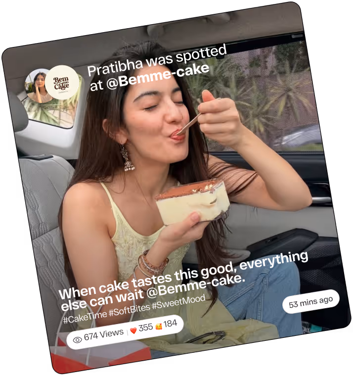A young woman happily eating a slice of cake while sitting in a car.