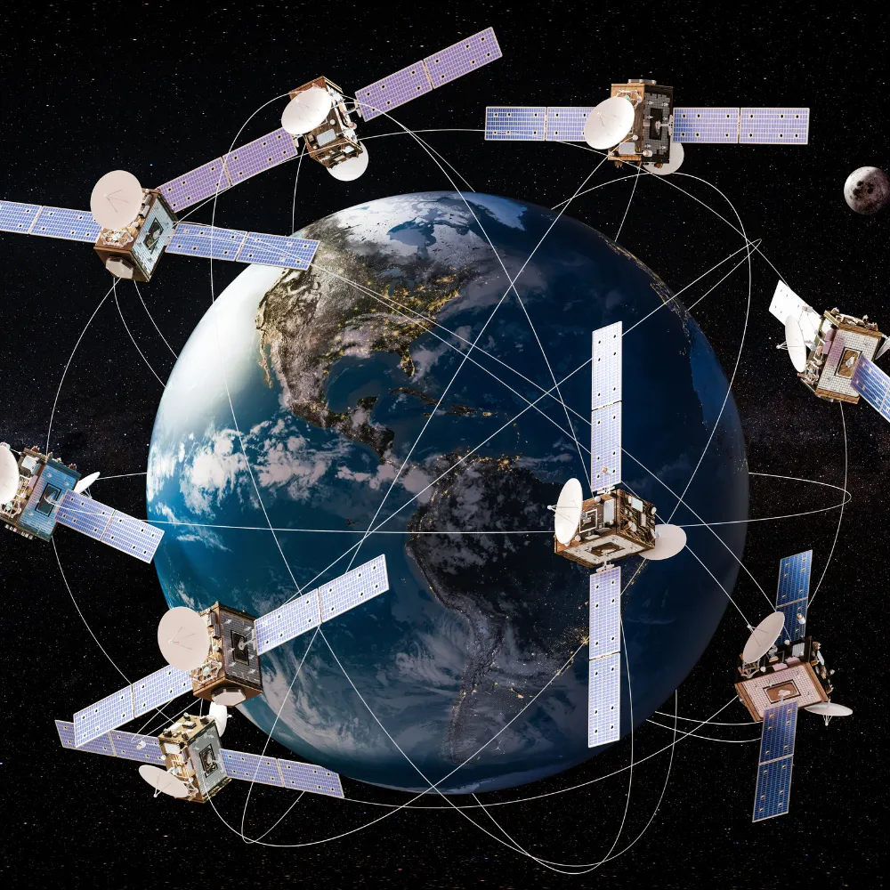 Multiple satellites orbiting Earth with visible network connection lines against a starry space background and the Moon in view.