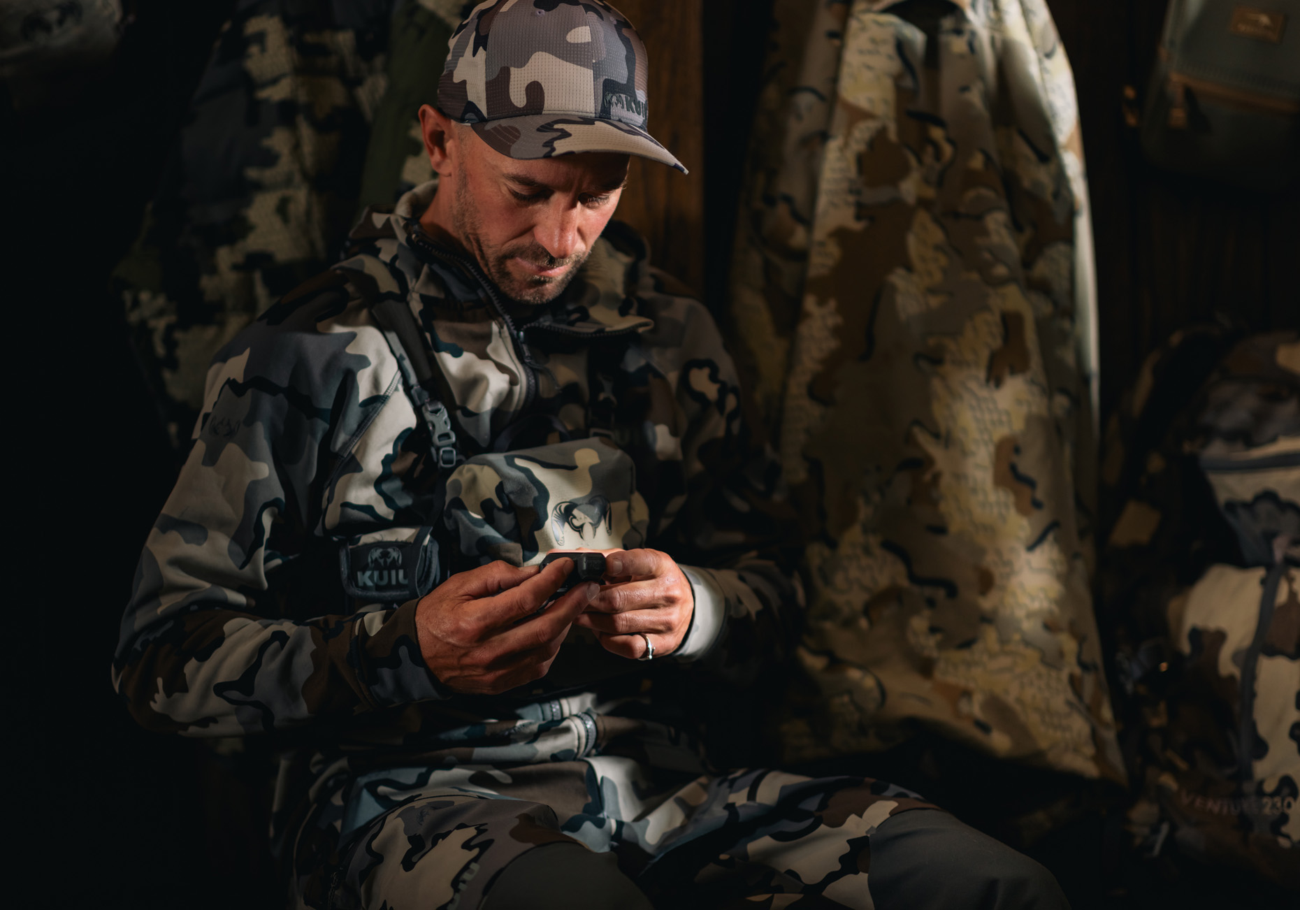 Commercial photography of a man dressed in camo at a hunting lodge.