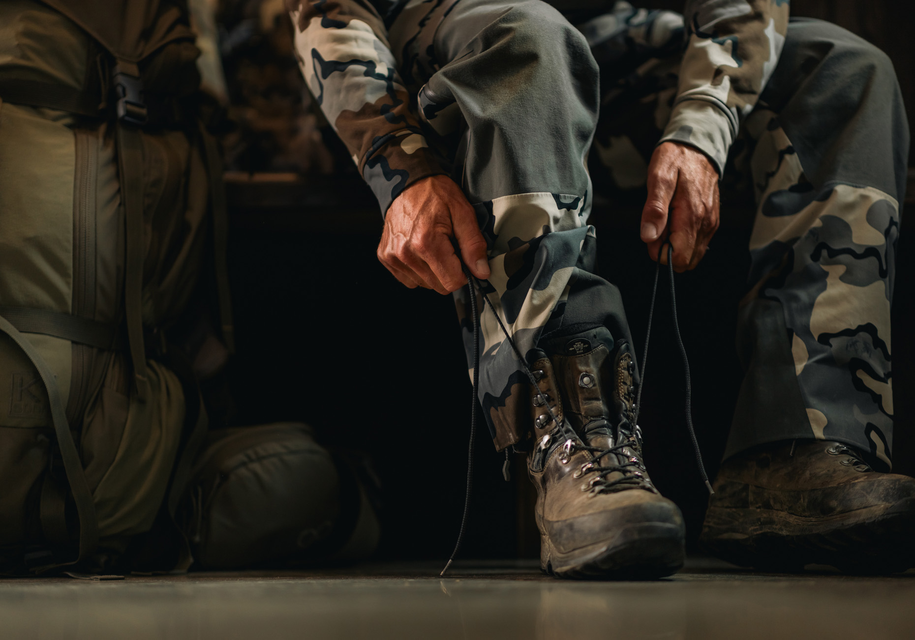 Commercial photography of a man dressed in camo at a hunting lodge.
