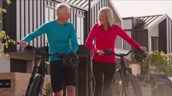 Two people with bikes. Commercial property developer video production, Queenstown NZ