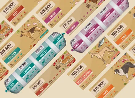 Assorted Big Dog pet food packages featuring chicken, beef, lamb, and Tasmanian salmon flavors with dog illustrations.