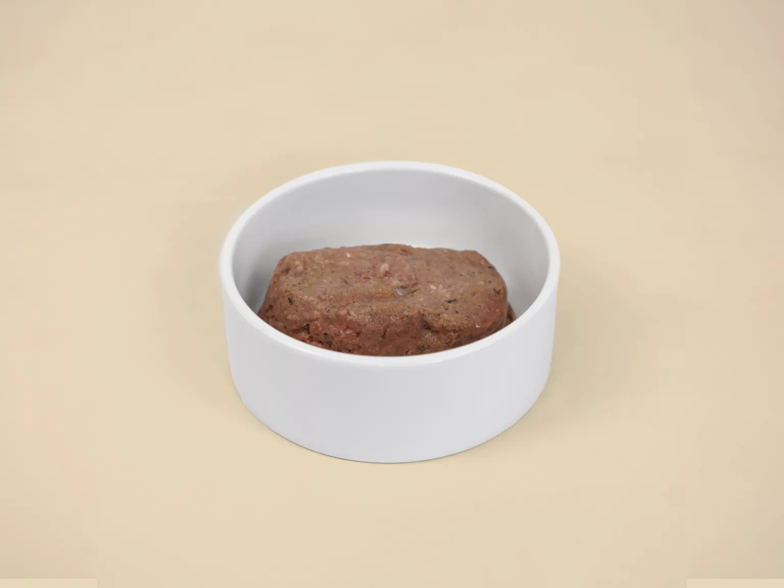A patty Sensitive Skin Raw Diet in a bowl