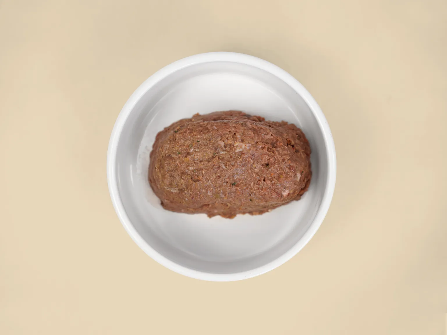 A patty of  Big Dog Pet Foods Wellbeing Raw Diet in a bowl.