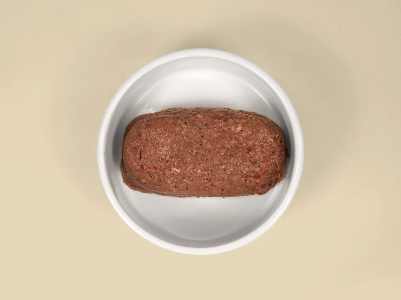 A patty of Lamb Raw Dog Food in a bowl.