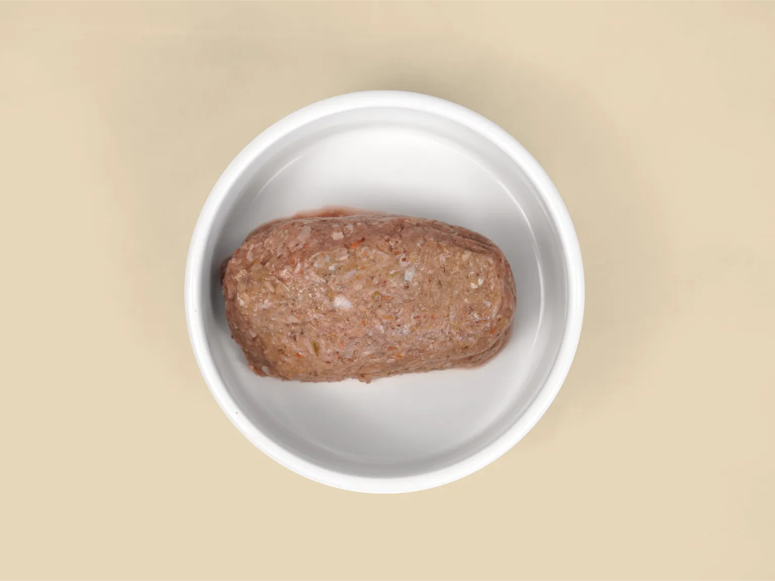 A patty of Big Dog Pet Foods Turkey Low Allergy, Single Protein Raw Diet in a bowl.