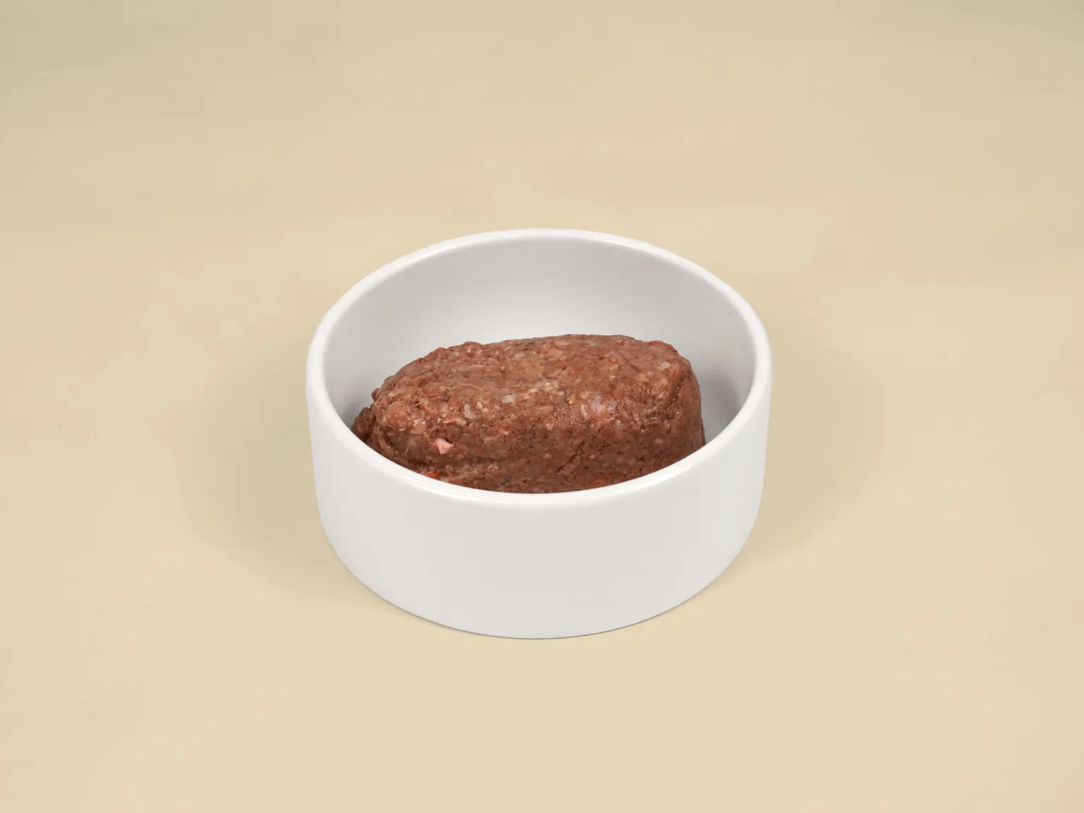 A patty of Big Dog Pet Foods Beef Raw Dog Food in a bowl.