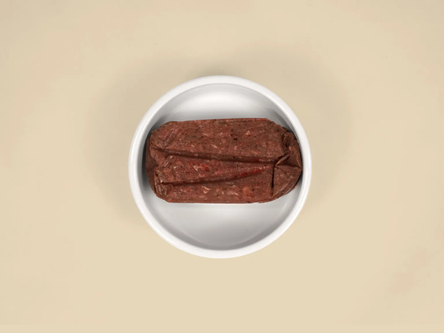 A patty of Kangaroo Raw Cat Food in a bowl.