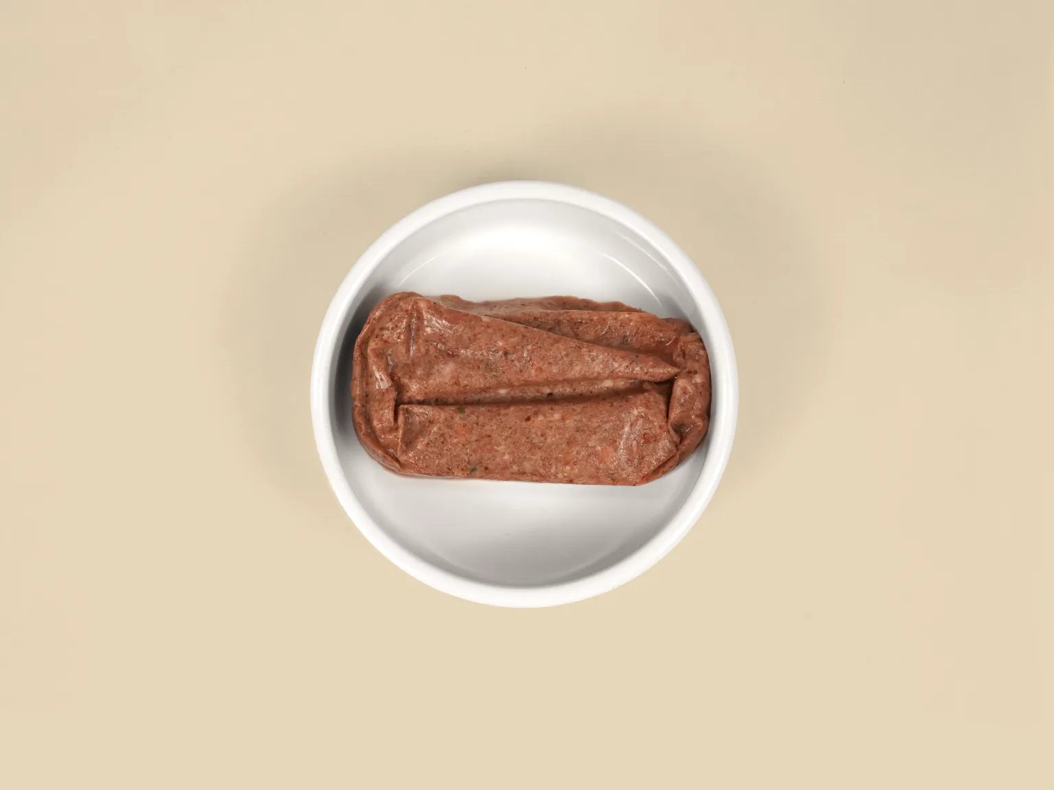A patty of Turkey Raw Cat Food in a bowl.