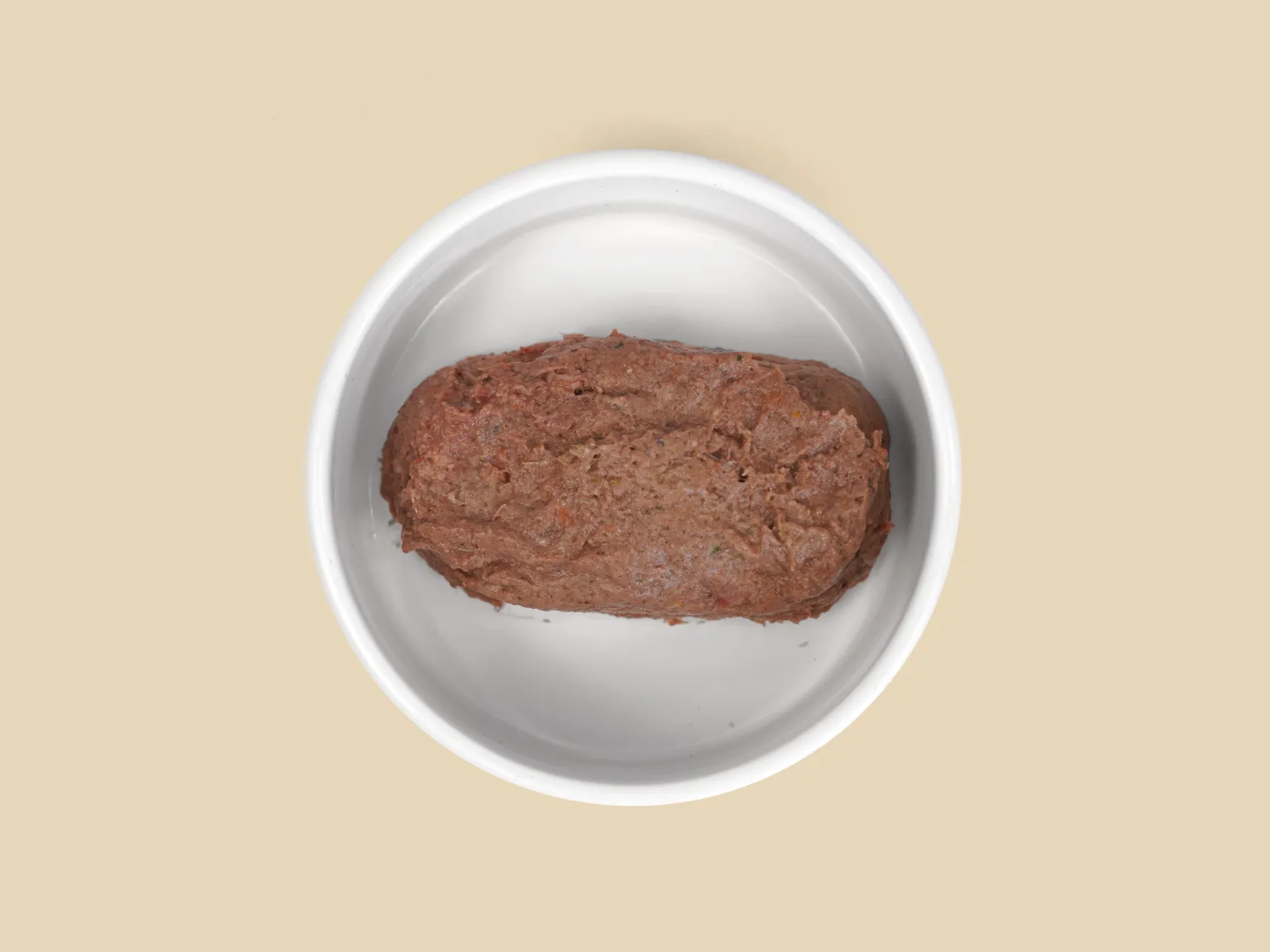 A patty of Goat Low Allergy, Single Protein Raw Diet in a bowl.