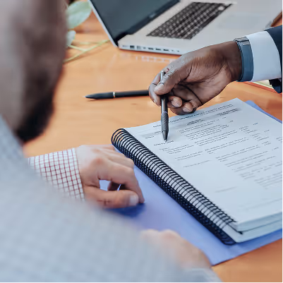 Couple reviewing property settlement documents with a lawyer, representing asset division after separation