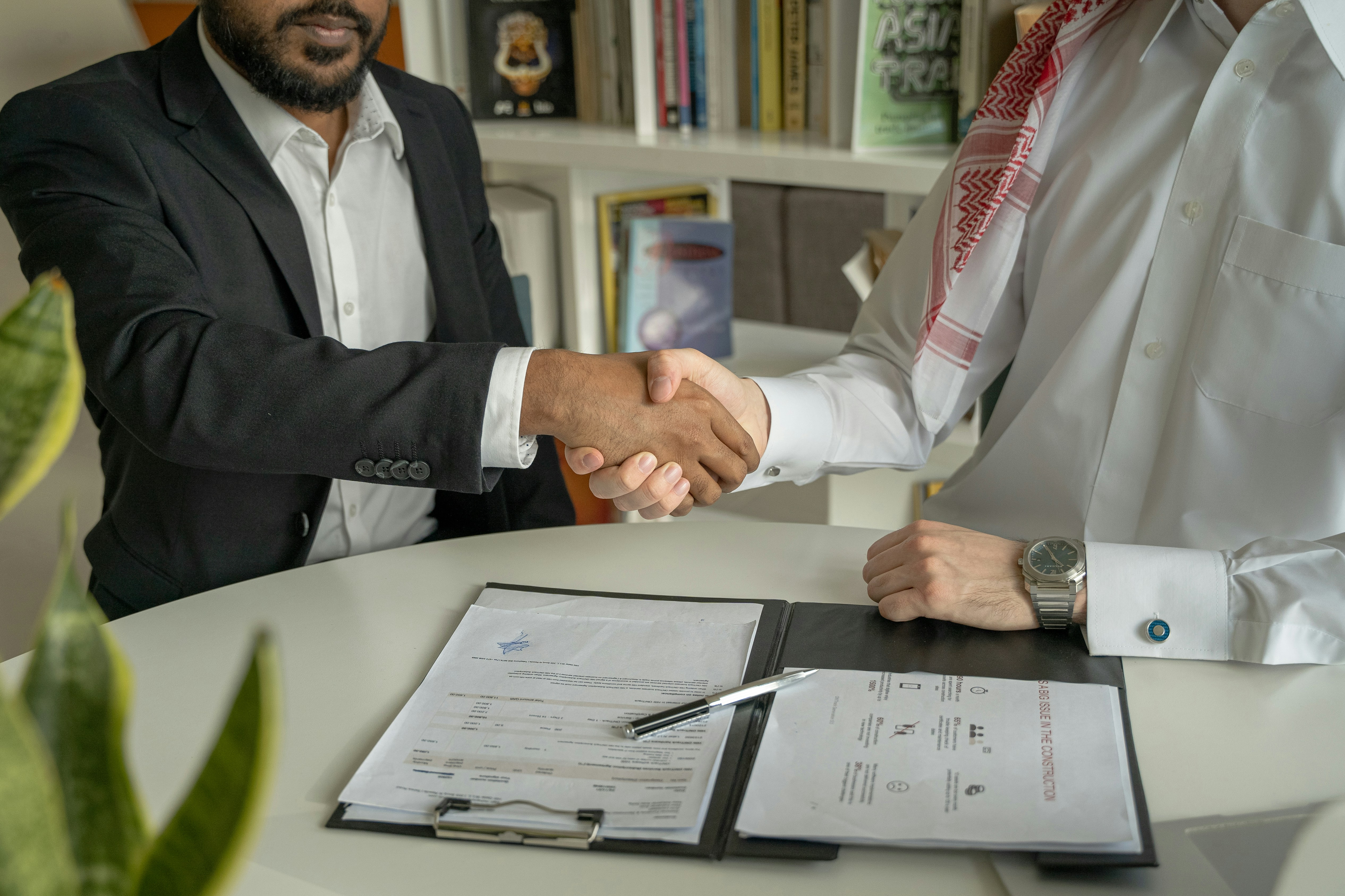 Person reviewing legal documents at a desk during a professional consultation