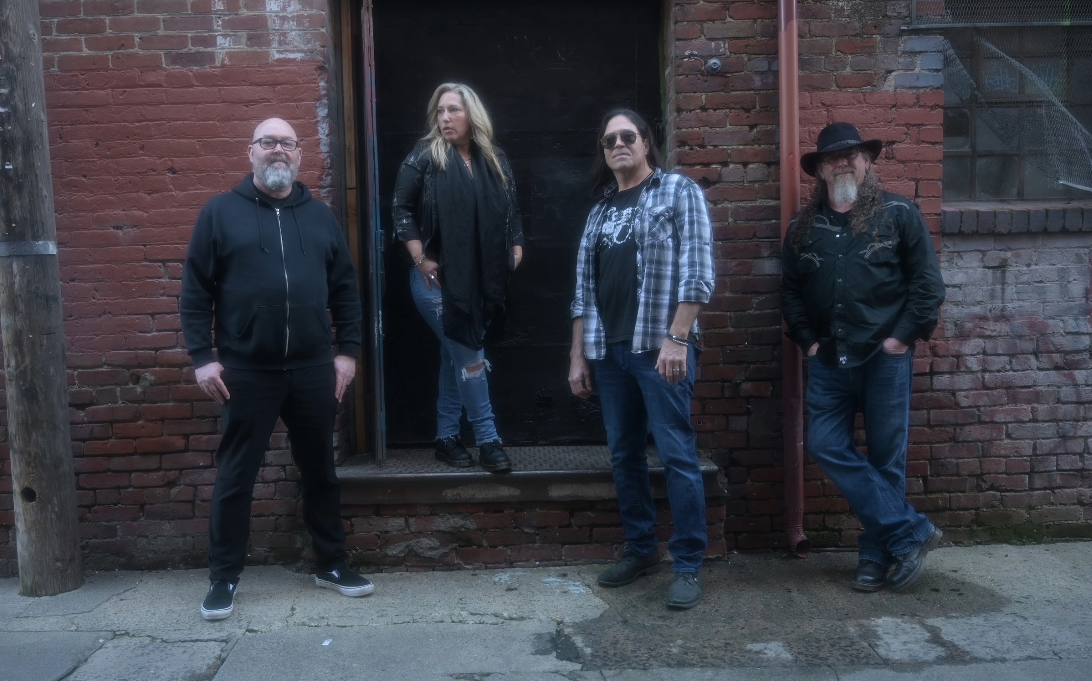 band photo against a white wall