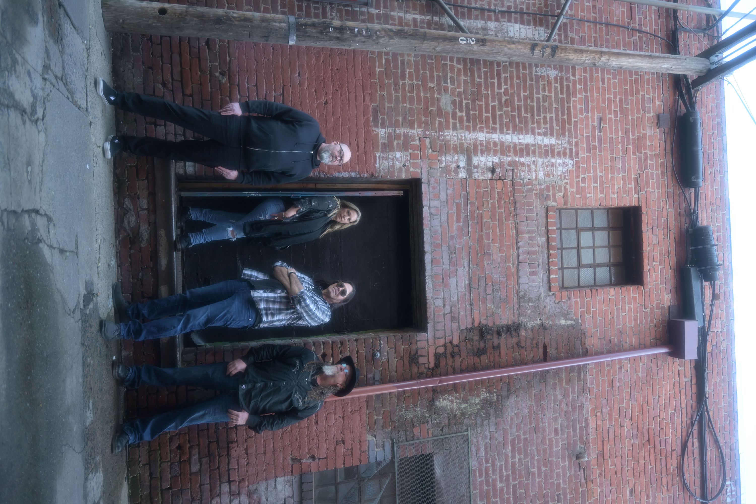 band photo in brick alley