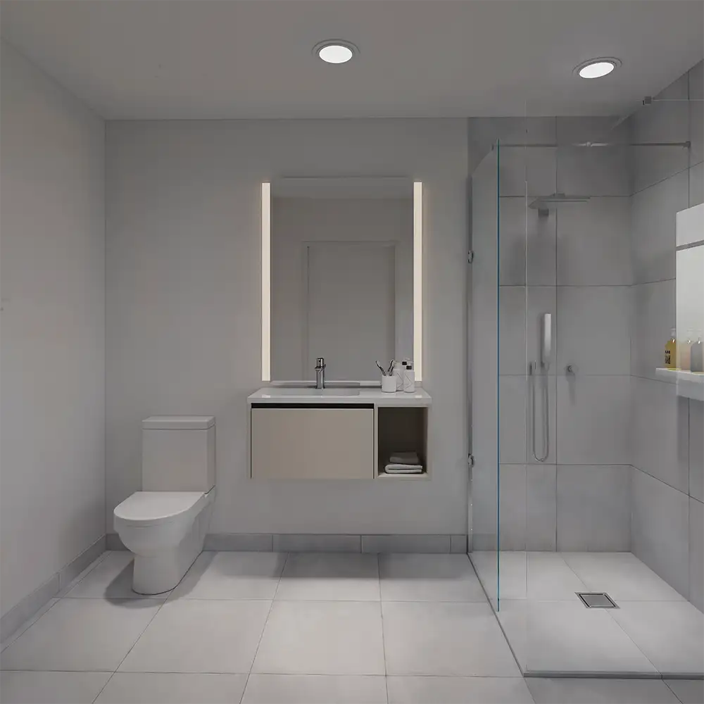 Minimalist bathroom with a wall-mounted sink, lighted mirror, toilet, and a glass shower enclosure.