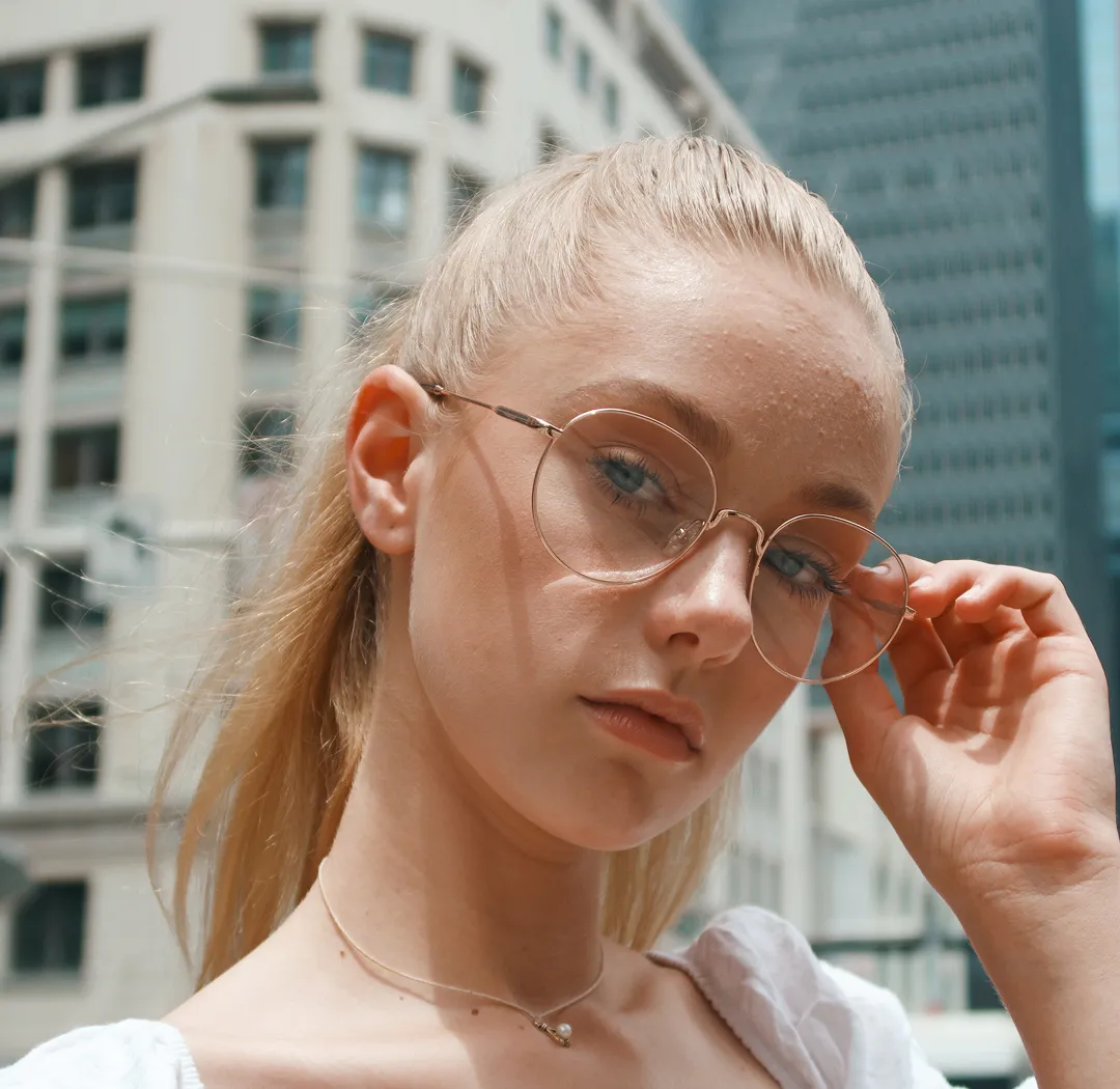Woman wearing stylish round prescription eyeglasses from independent opticians