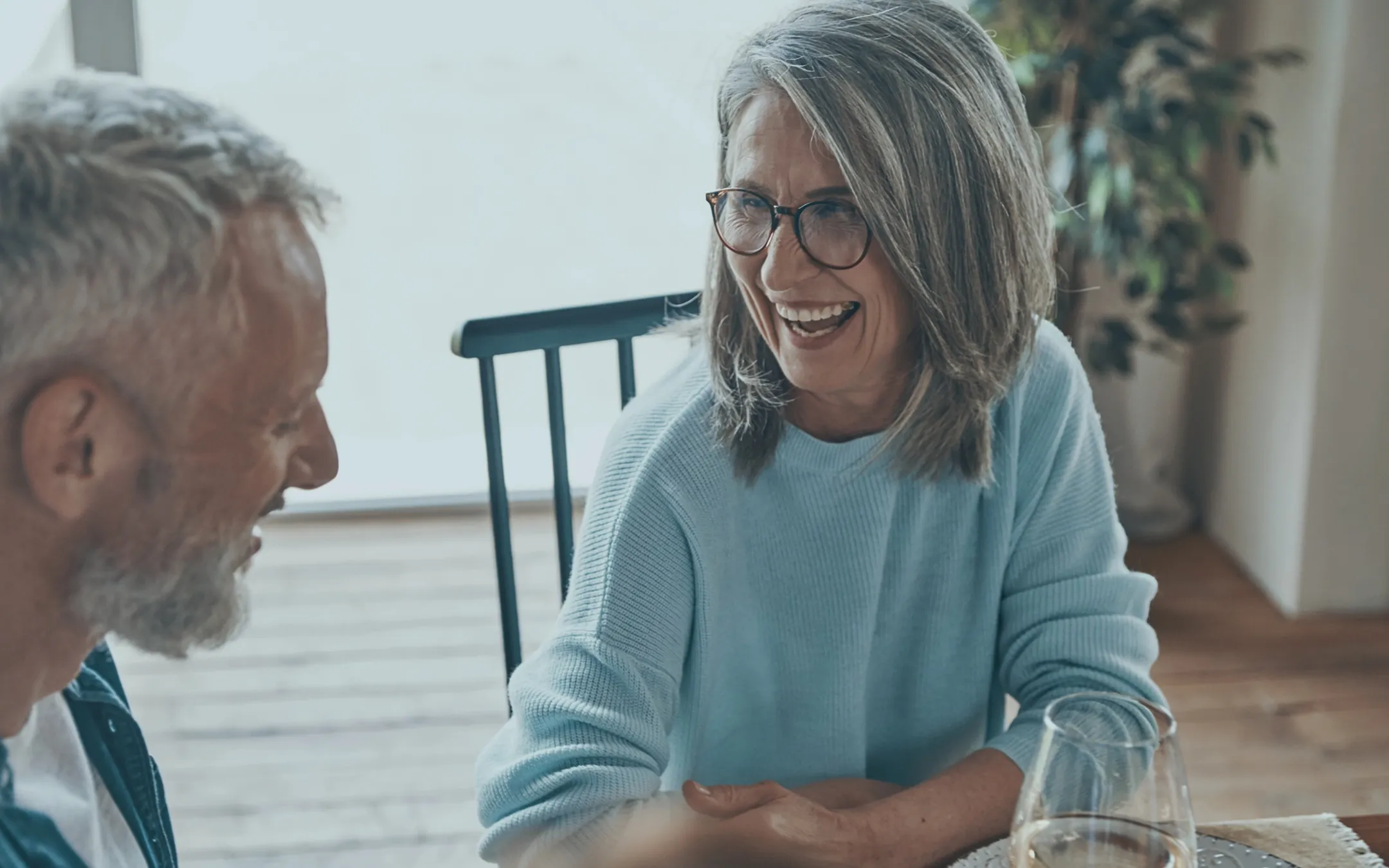 Happy mature couple enjoying improved hearing and vision with hearing care and eyewear from opticians