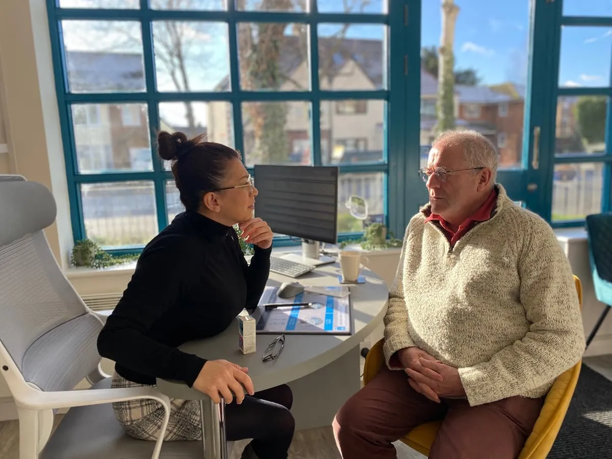 Optician consulting with patient