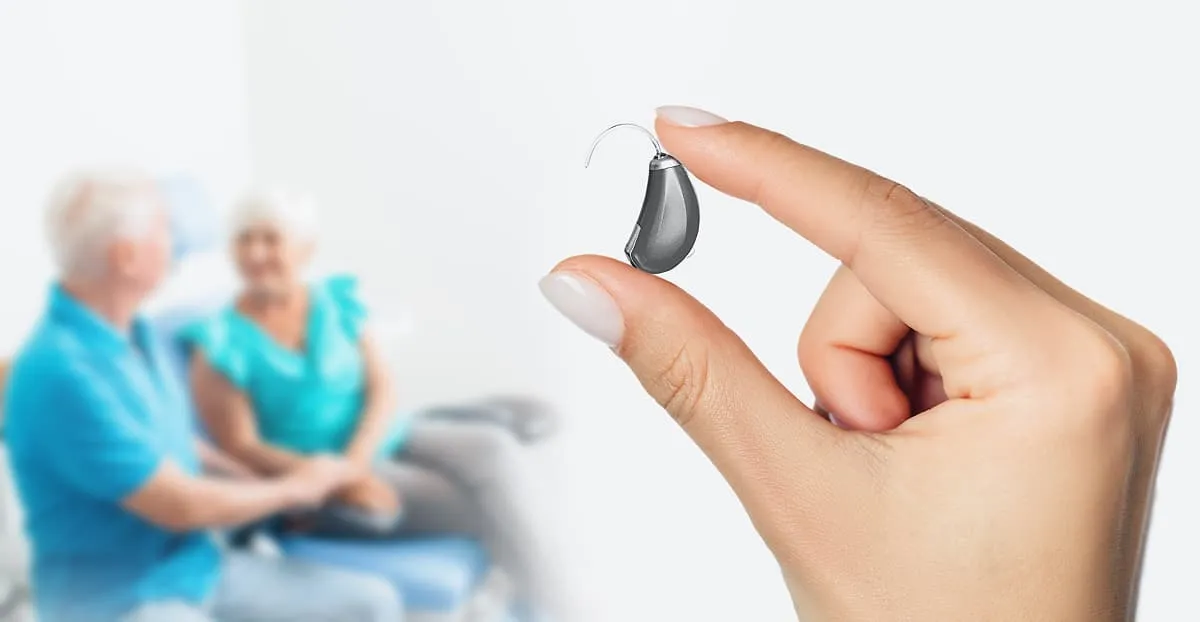 Hearing aid device held between fingers