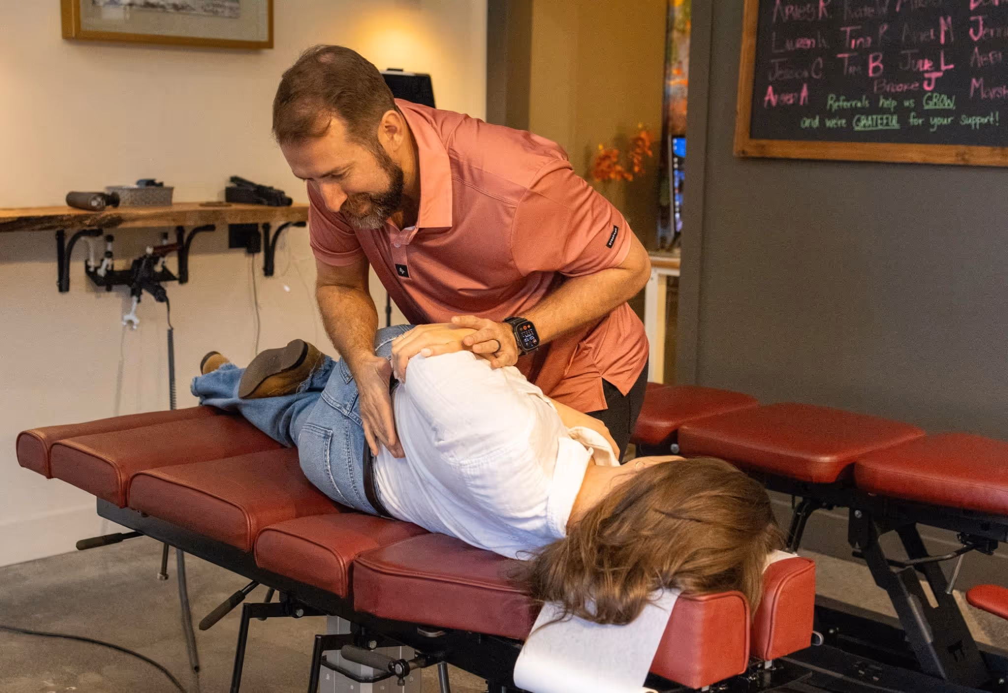 Dr. Ben performing a chiropractic adjustment on a patient lying on a treatment table as part of a lower back pain treatment plan in Fayetteville.