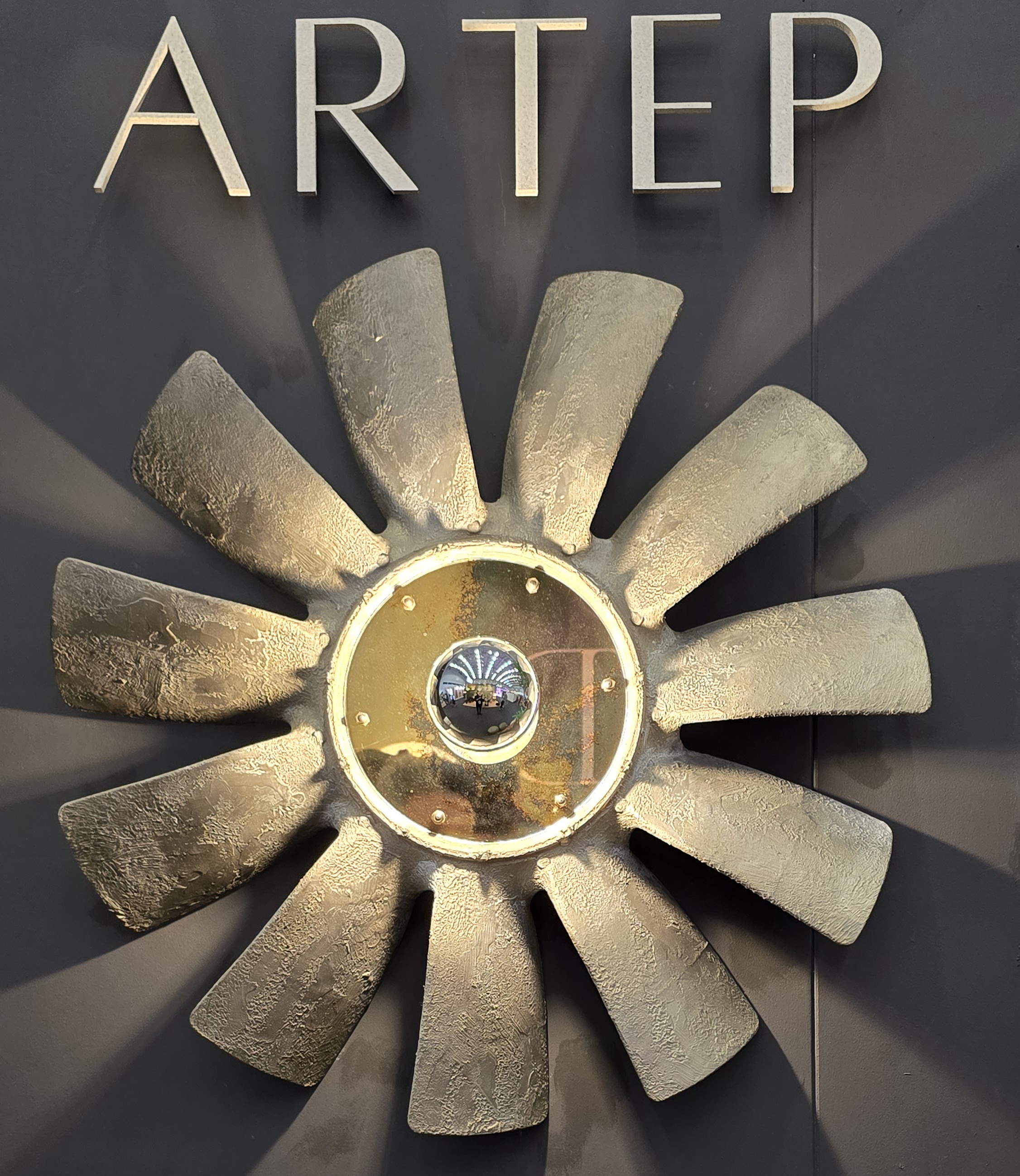 Multiple Gold Bloom Light fittings in a back drop of wall tiles