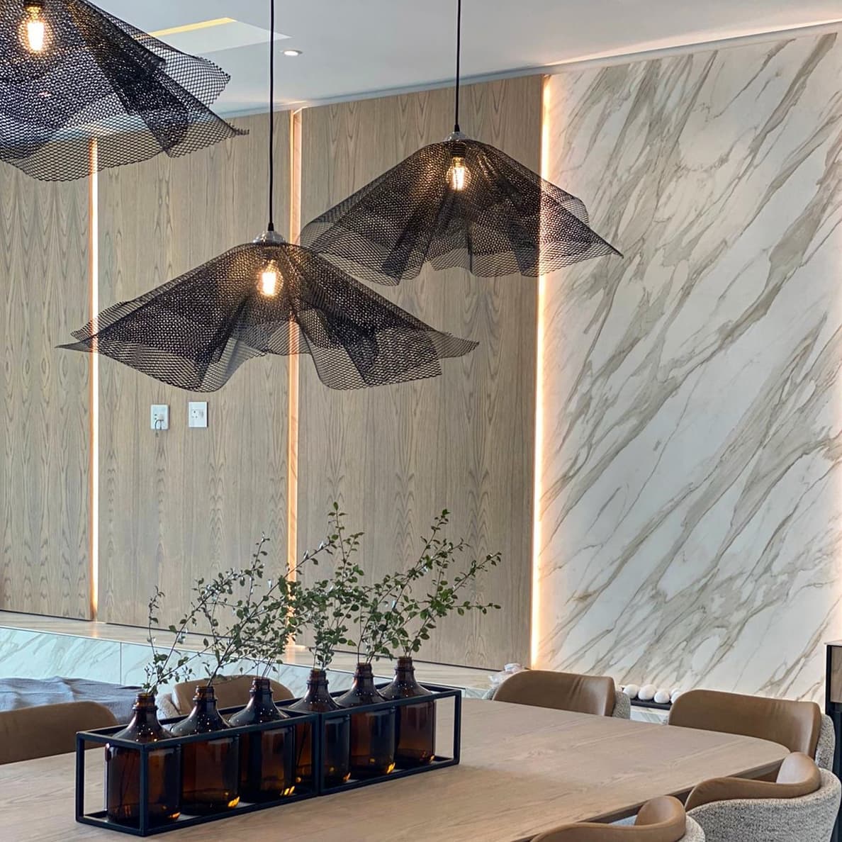 A Light Sculpture installation in black petals over a reception area