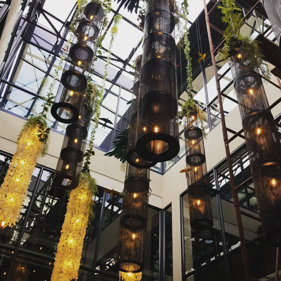 A custom installation of lights in glass, and metal with ceramic birds