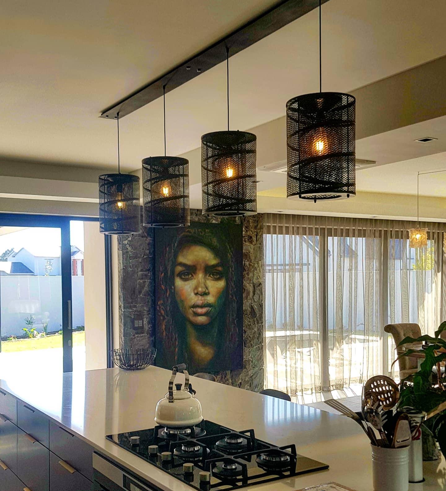 Black Twirly Whirly Pendants over a dining room in an interior designed curated space