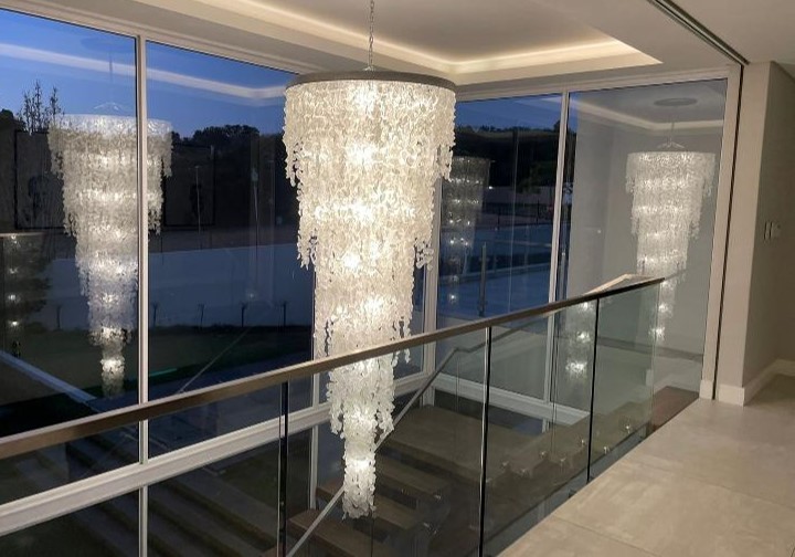 A crystal double volume chandelier in a stair case