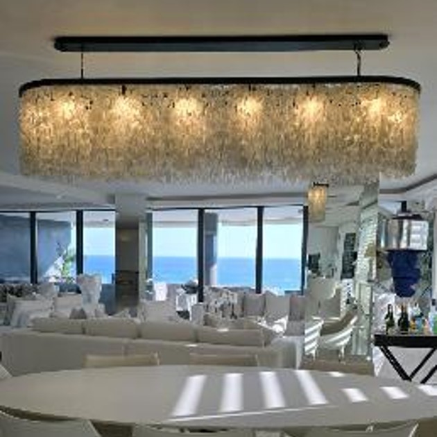 An oval shaped white glass chandelier.  In Llandadno