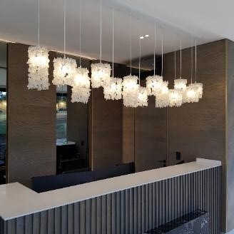Multiple small pendant glass crystal lights installed over bar