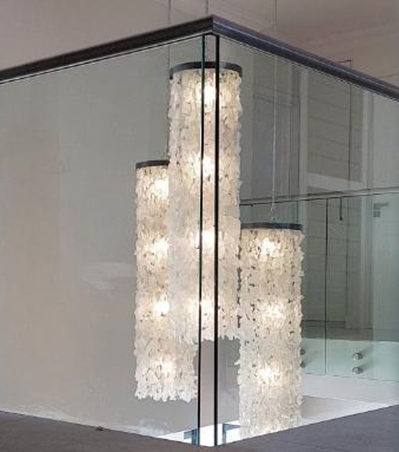 Three double volume glass column light features on the second story