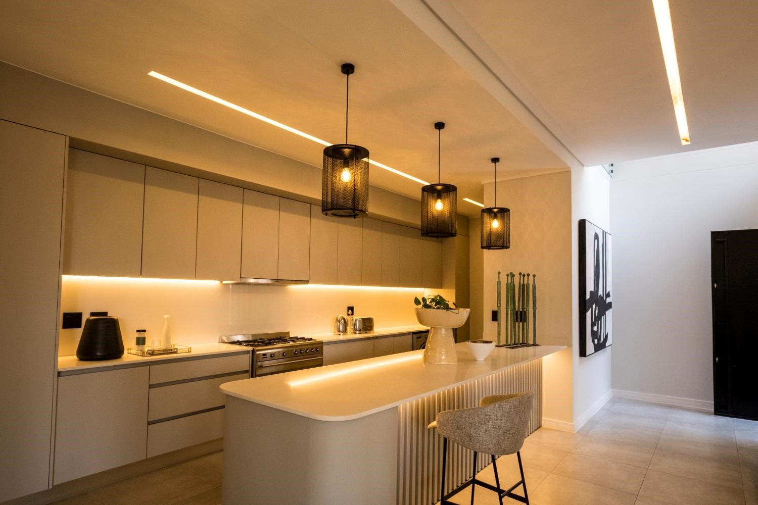 Three pendants in black over a kitchen island
