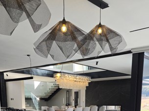 Three pendants in black over a kitchen island installed at Val de Vie Estate in Paarl