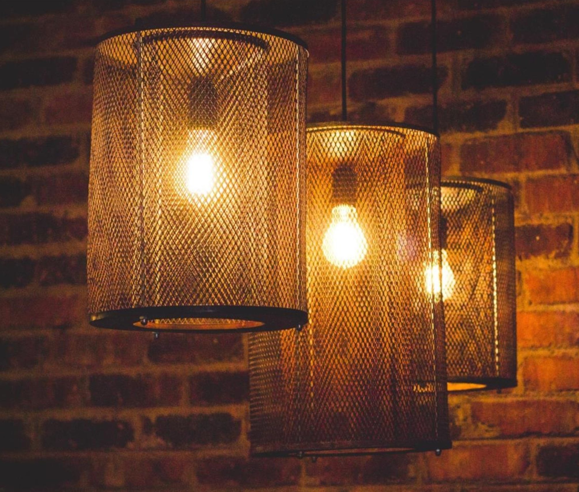 3 Brass recycled Pendants in a bar.