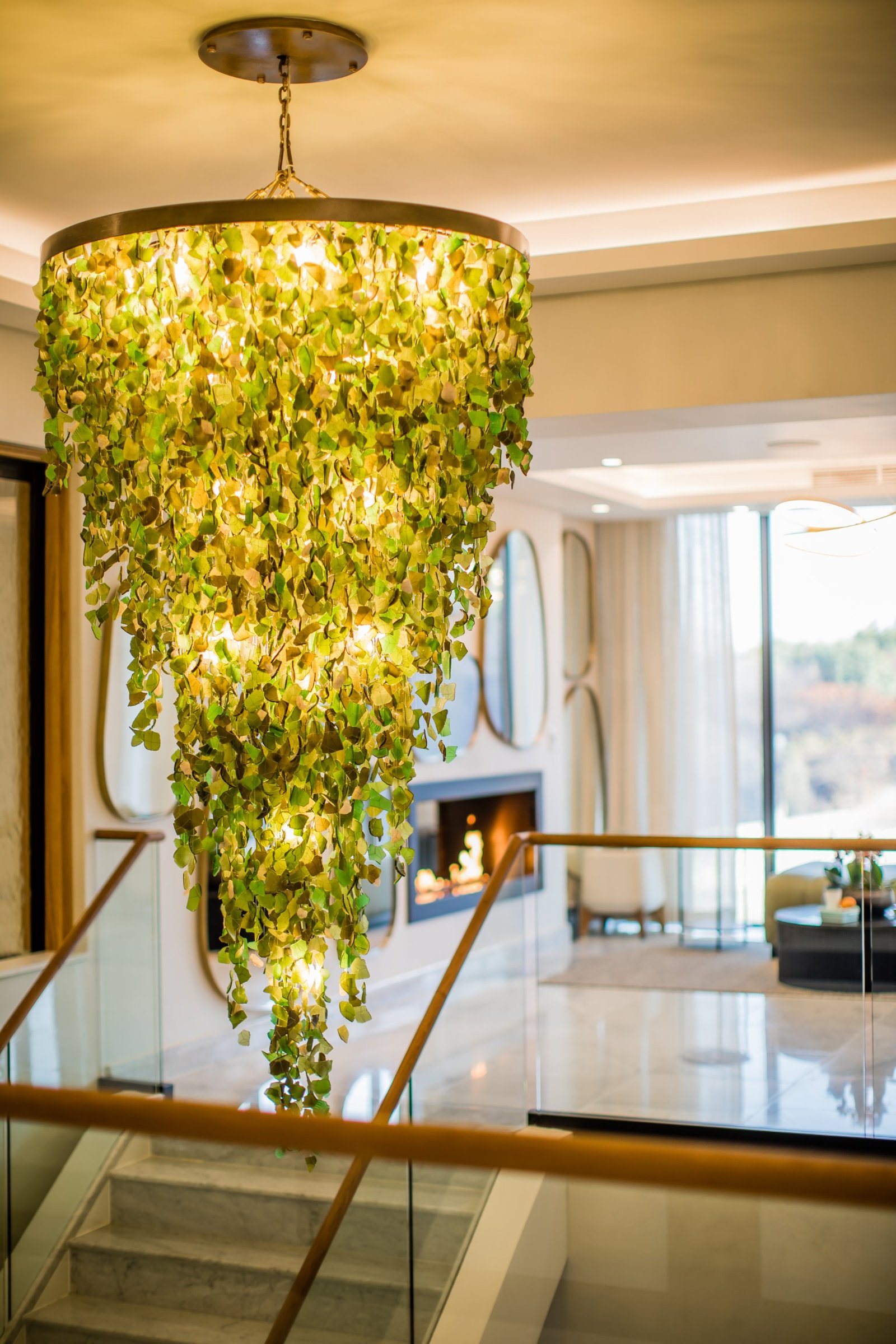 A massive tiered custom crystal chandelier for double volume space