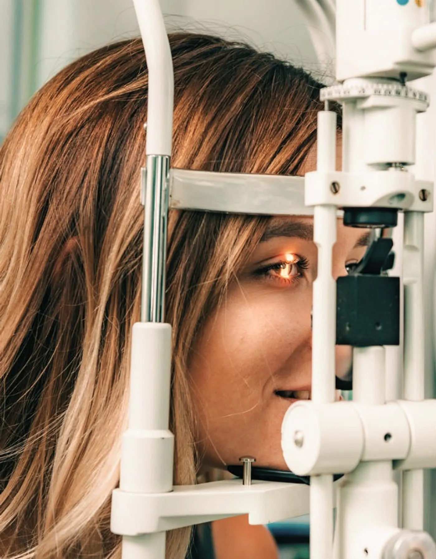 Woman having her eyes tested by optometrist